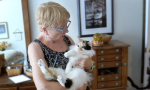 Peggy Guin holds a black and white cat