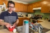 Walfre Lopez uses his artificial-vision system to prepare a meal at his home in Dalton, Georgia. Lopez was the first University of Florida Health patient to receive the Argus II Retinal Prosthesis System during a procedure earlier this year. 